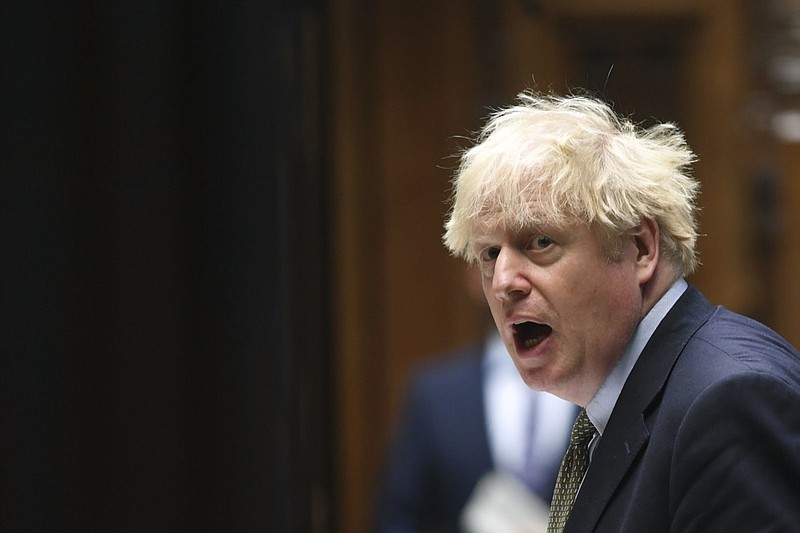 In this photo released by UK Parliament, Britain's Prime Minister Boris Johnson speaks, during Prime Minister's Questions in the House of Commons, London, Wednesday, Oct. 14, 2020. Johnson is being criticized by all sides two days after announcing his three-tier approach. A report Tuesday showed that the government's science advisers had urged it to impose much tougher measures, including a two- to three-week national lockdown. (Jessica Taylor/UK Parliament via AP)
