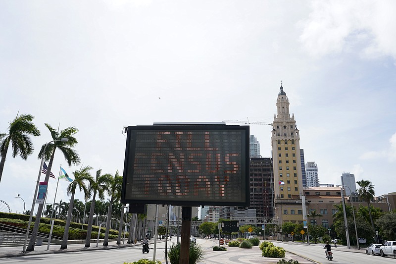 In this Oct. 5, 2020, file photo, a flashing sign near the iconic "Freedom Tower," advises people to fill out their census forms in downtown Miami. The Supreme Court's decision to allow the Trump administration to end the 2020 census was another case of whiplash for the census, which has faced stops from the pandemic, natural disasters and court rulings. (AP Photo/Wilfredo Lee)