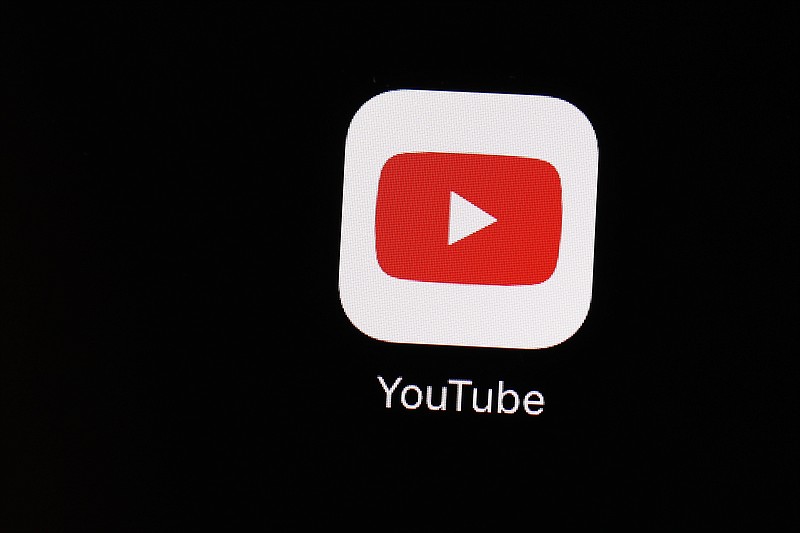 FILE - This March 20, 2018 file photo shows the YouTube app on an iPad in Baltimore. YouTube is following the lead of Twitter and Facebook, saying that it is taking more steps to limit QAnon and other baseless conspiracy theories that can lead to real-world violence. The Google-owned video platform said Thursday, Oct. 15, 2020 it will now prohibit material targeting a person or group with conspiracy theories that have been used to justify violence. (AP Photo/Patrick Semansky, File)