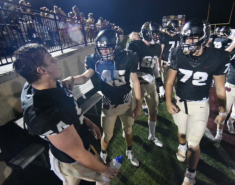 Staff photo by Matt Hamilton / Teammates congratulate Christian Heritage linebacker Ben Williamson, lefft, after he intercepted a pass during a home game on Sept. 25 in Dalton, Ga.