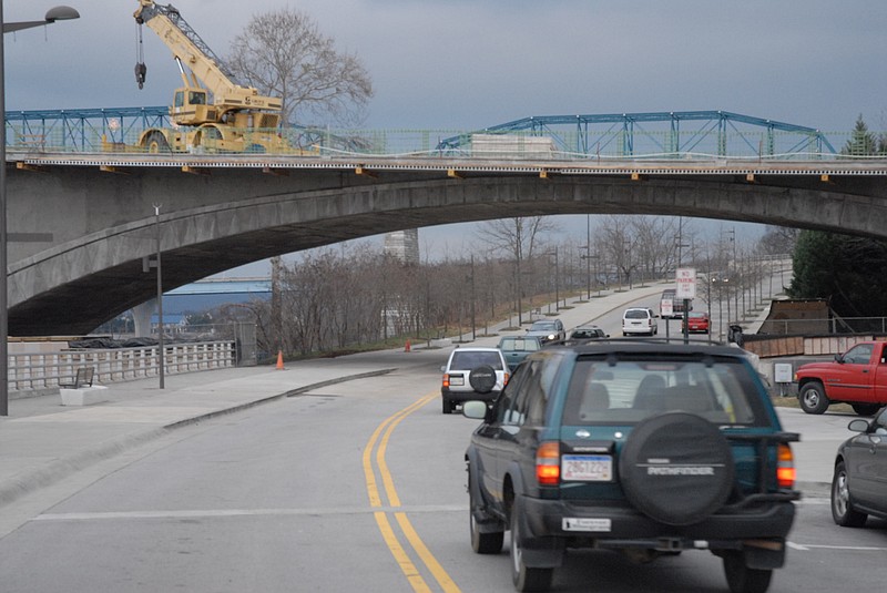 Staff file photo / Riverfront Parkway traffic near the Tennessee Aquarium passes beneath the Market Street bridge, which was undergoing a refurbishment at the time of this file photo.