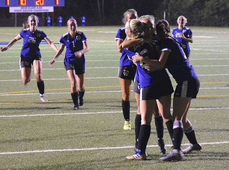 Staff photo by Patrick MacCoon / Boyd Buchanan senior Emma Vinson (6) is swarmed by teammates after scoring one of her three goals in Thursday's 4-3 overtime win against visiting Silverdale Baptist Academy to win the Division II-A East Region championship.