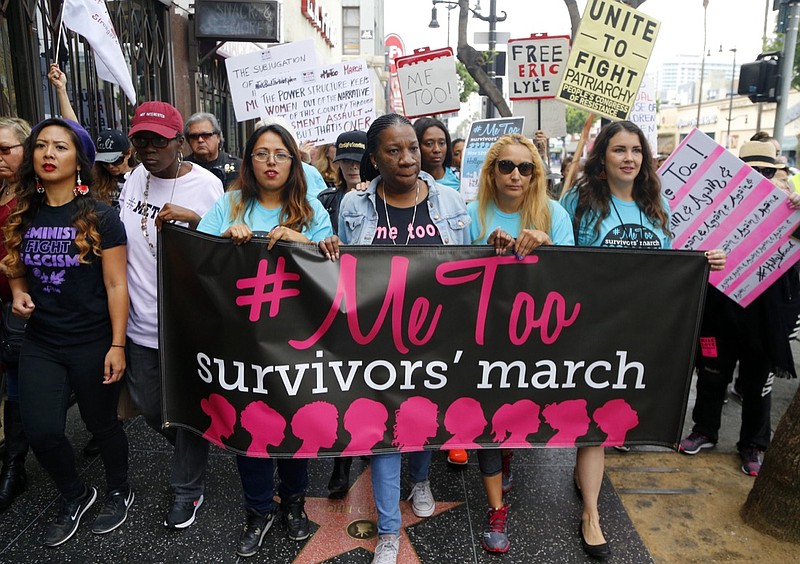 FILE - In this Nov. 1, 2017, file photo, Tarana Burke, founder and leader of the #MeToo movement, marches with others at the #MeToo March in the Hollywood section of Los Angeles. As the #MeToo movement marks the third year since it received global recognition, Burke is working to make sure it remains inclusive and reclaims its original intent: A focus on marginalized voices and experiences. (AP Photo/Damian Dovarganes, File)