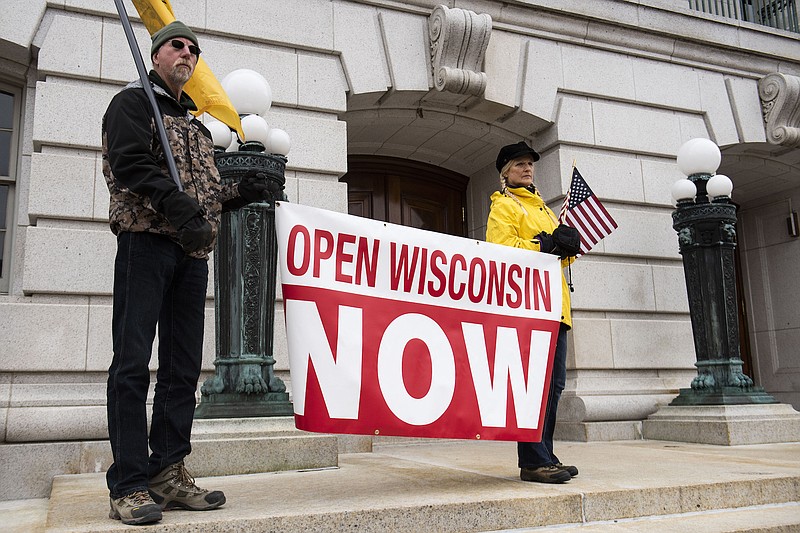 File photo by Lauren Justice of The New York Times / Protesters against Gov. Tony Evers' stay-at-home order for Wisconsin gather at the Wisconsin State Capitol building in Madison on Friday, April 24, 2020. The order was set in place due to the coronavirus pandemic.