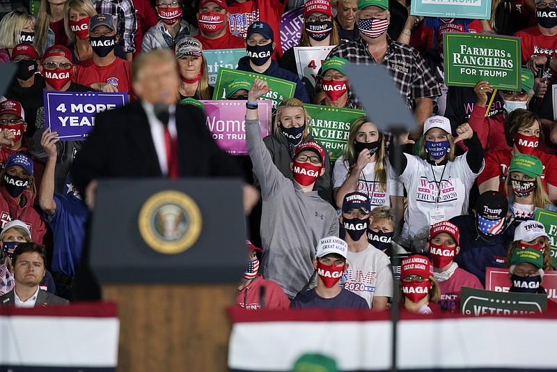 In this Oct. 14, 2020, file photo supporters react as President Donald Trump speaks at a campaign rally at Des Moines International Airport in Des Moines, Iowa. The overwhelming majority of voters believe the nation is deeply divided over its most important values and many have doubts about the health of the democracy itself. And supporters of President Donald Trump and Joe Biden alike think the opposing candidate will make things even worse if elected, according to a new poll from The Associated Press-NORC Center for Public Affairs Research. (AP Photo/Charlie Neibergall, File)