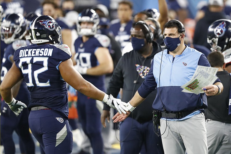 AP photo by Wade Payne / Tennessee Titans coach Mike Vrabel slaps hands with defensive end Matt Dickerson during Tuesday's home win against the Buffalo Bills.