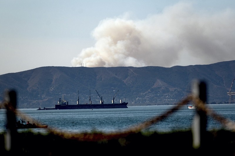 Seen from Alameda, Calif., a grass fire burns in South San Francisco on Friday, Oct. 16, 2020. Portions of Northern California remain under red flag fire warnings due to high temperatures and dry winds. (AP Photo/Noah Berger)


