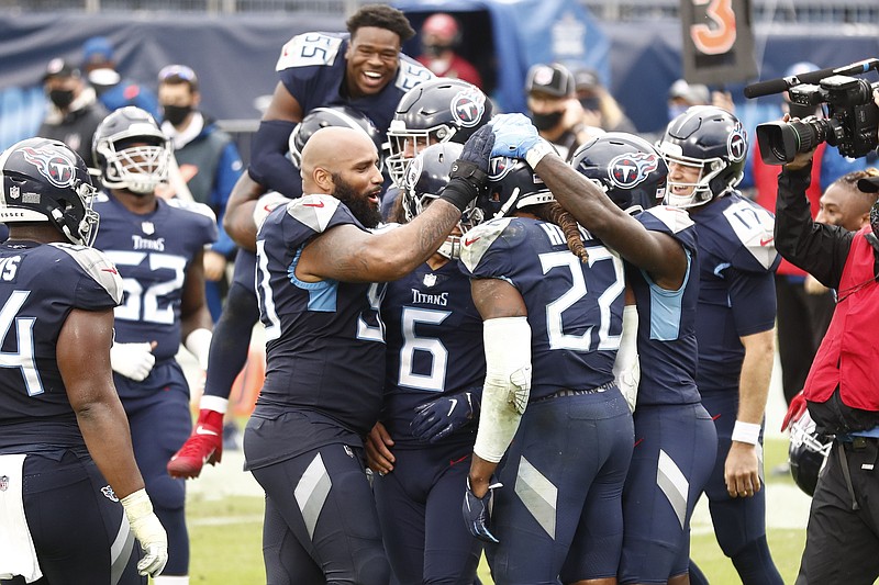 AP photo by Wade Payne / Tennessee Titans running back Derrick Henry (22) is congratulated by teammates after he scored the winning touchdown against the Houston Texans in overtime Sunday in Nashville. The Titans won the matchup of AFC South rivals 42-36 to improve to 5-0, the second-best start in franchise history.