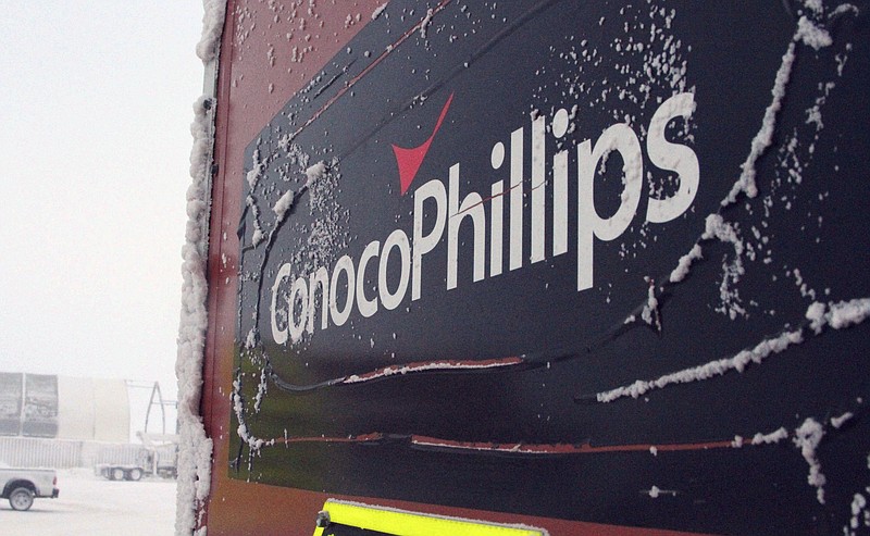 FILE - This Feb. 9, 2016, file photo shows an ice-covered ConocoPhillips sign at a drilling site in Nuiqsut, Alaska. ConocoPhillips is buying shale producer Concho Resources in an all-stock deal valued at $9.7 billion. The companies said Monday, Oct. 19, 2020, that the combined business will be the largest independent oil and gas company, with pro forma production of more than 1.5 million barrels of oil equivalent per day.  (AP Photo/Mark Thiessen, File)