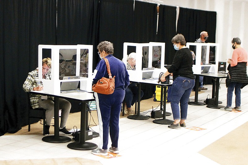 Voters check-in to vote at the Foothills Mall on the first day of early voting for the general election, Wednesday, Oct. 14, 2020, in Maryville, Tenn. (Tom Sherlin/The Daily Times via AP)