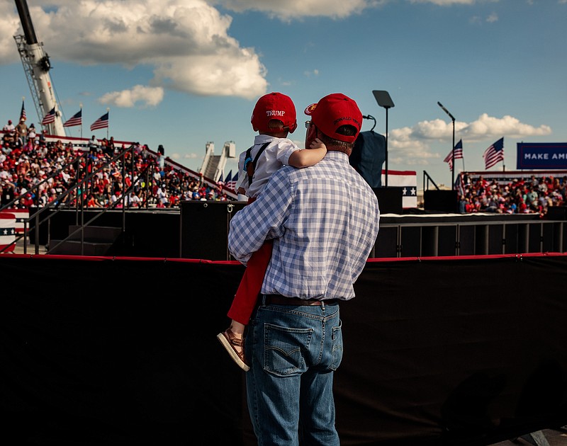 Photo by Damon Winter of The New York Times / Supporters wait for President Donald Trump during his first campaign event since testing positive for COVID-19 at the Orland Sanford International Airport in Sanford, Florida, on Oct. 12, 2020.