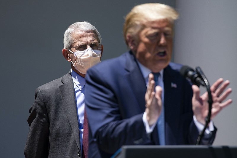 New York Times file photo/Dr. Anthony Fauci, the nation's leading infectious disease specialist, looks on as President Donald Trump speaks to reporters at the White House on May 15. Trump attacked Fauci as "a disaster" on Monday and said that people are "tired" of hearing about the coronavirus.