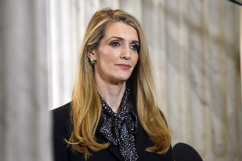 In this March 20, 2020, file photo, U.S. Sen. Kelly Loeffler, R-Georgia, waits to speak in a television interview on Capitol Hill in Washington. Candidates in the special election for the U.S. Senate seat held by Loeffler are set to square off in their first debate Monday, Oct. 19, 2020. Loeffler faces a large field including Democrat Raphael Warnock and fellow Republican Doug Collins in a race for the seat she was appointed to 10 months earlier. (AP Photo/Susan Walsh, File)