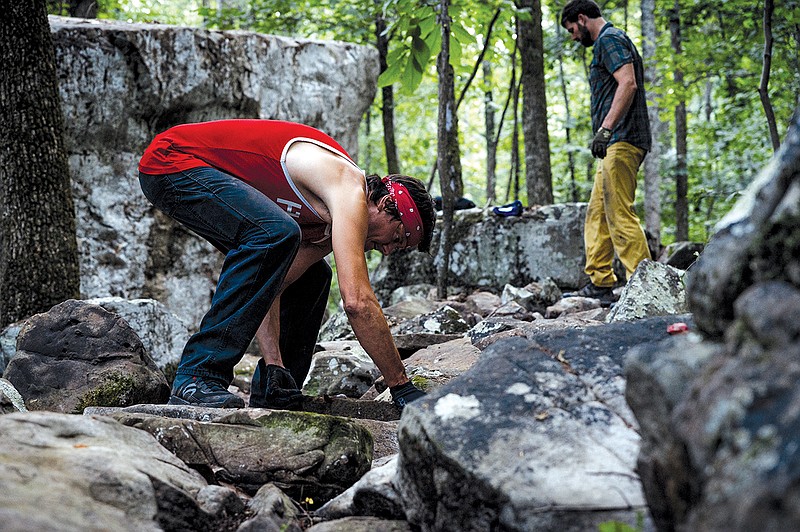 Photo by Nathalie Dupre' / Local rider and SORBA volunteer, Chad Oliver, works on rock armor design at Walden's Ridge Park.