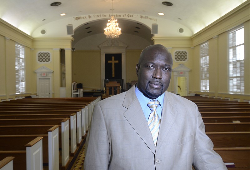 Staff Photo by Angela Lewis Foster/ The Chattanooga Times Free Press- 10/03/14. Pastor Ezra Maize stands in Friendship Central Church on Friday afternoon.