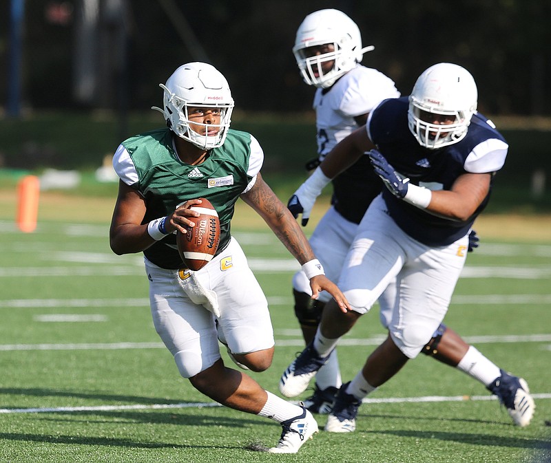 Staff photo by Erin O. Smith / University of Tennessee at Chattanooga quarterback Drayton Arnold (3) looks to throw a pass downfield during football practice Thursday, August 8, 2019 at Scrappy Moore field in Chattanooga, Tennessee. 