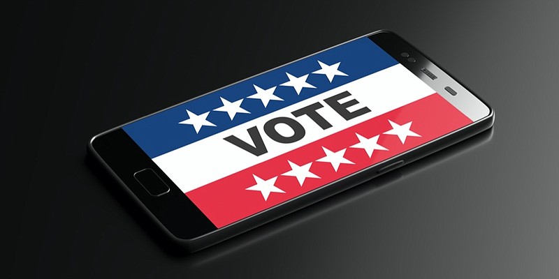 Online election, digital Voting on US America election day concept. VOTE text on a mobile phone display, black background. 3d illustration phone election tile politics text message tile / Getty Images
