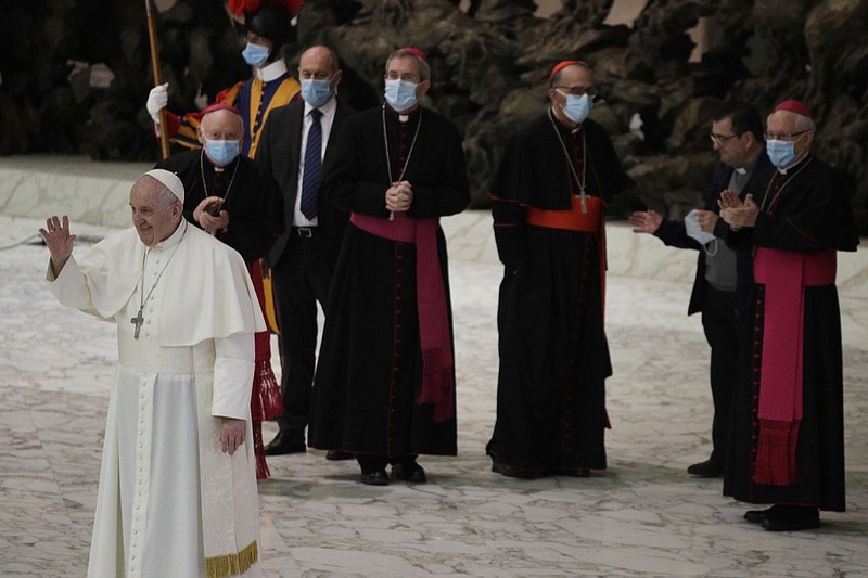 Pope Francis waves to faithful at the end of the weekly general audience in the Paul VI hall at the Vatican, Wednesday, Oct. 21, 2020. (AP Photo/Gregorio Borgia)