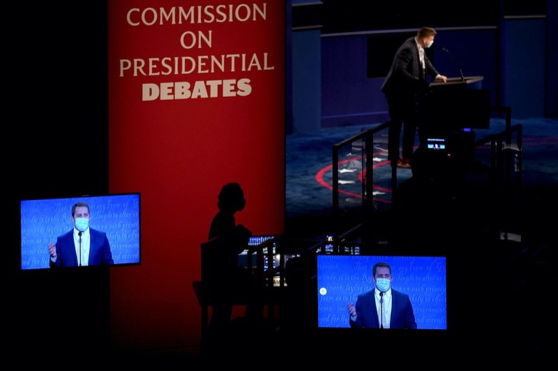 Stand-ins participate in rehearsal tests ahead of the final presidential debate between Republican candidate President Donald Trump and Democratic candidate former Vice President Joe Biden, Wednesday, Oct. 21, 2020, in Nashville, Tenn. The debate will take place Thursday, Oct. 22 at the Curb Event Center at Belmont University. (AP Photo/Julio Cortez)


