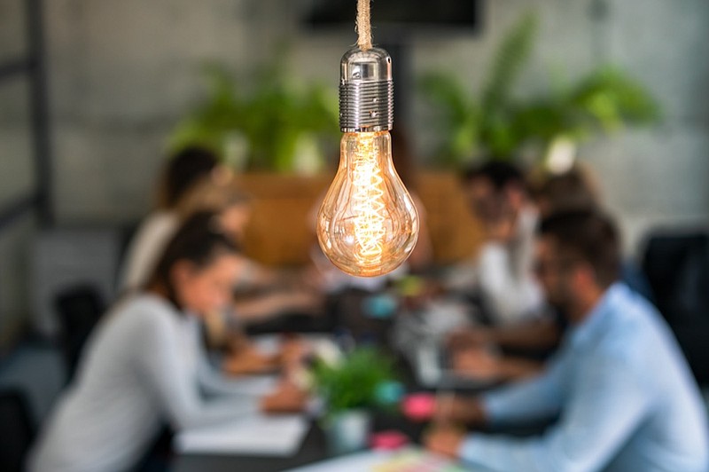 Young business people are discussing together a new startup project. A glowing light bulb as a new idea. business tile startup light bulb tile lightbulb / Getty Images
