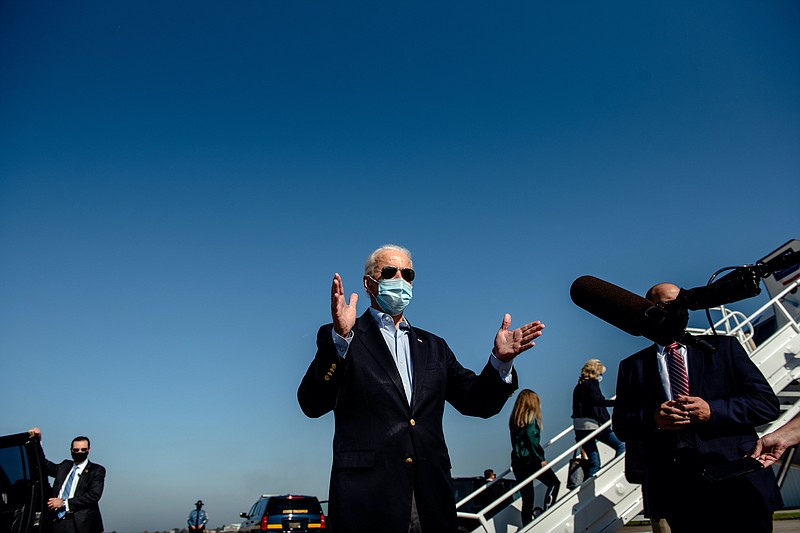 New York Times photo by Hilary Swift/Joe Biden wears a mask and practices social distancing as he speaks with reporters before flying to Nashville for Thursday's debate with President Donald Trump.