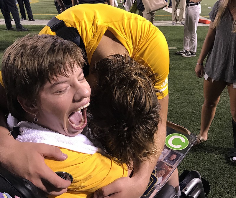Photo contributed by Troy and Karen Boeck / UTC linebacker Ty Boeck, leaning over, has a special relationship with his sister Emily, who has rarely missed a chance to watch and encourage him since his high school playing days.