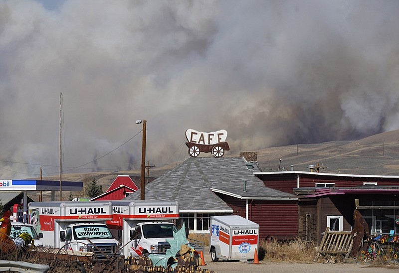 Smoke rises from mountain ridges as a wildfire burns south of Highway 34 Thursday, Oct. 22, 2020, near Granby, Colo. (AP Photo/David Zalubowski)