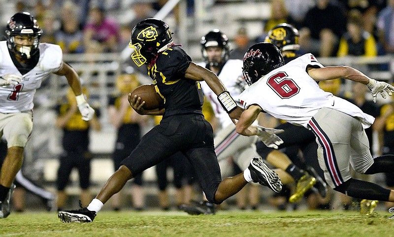 Staff Photo by Robin Rudd / McMinn's Jalen Hunt (17) makes a move to elude two Rebel defenders. The McMinn County Cherokees hosted the Maryville Rebels in a battle of two top-five TSSAA football teams on October 23, 2020.
