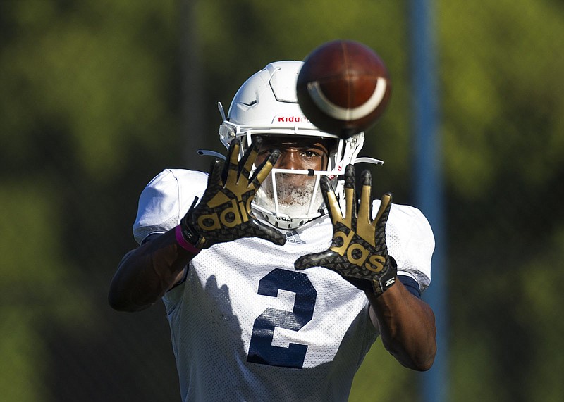 Staff photo by Troy Stolt / UTC wide receiver Kanore McKinnon tracks the ball into his hands during a Sept. 30 practice at Scrappy Moore Field.