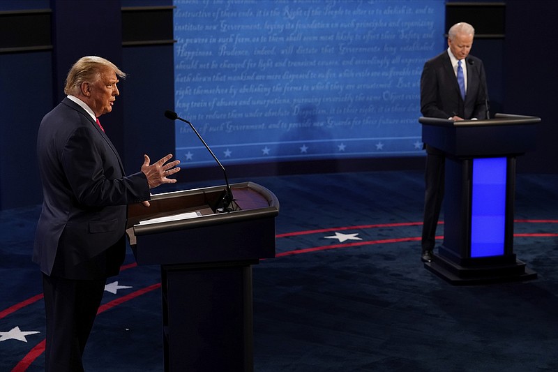 The Associated Press / President Donald Trump answers a question as Democratic presidential candidate former Vice President Joe Biden takes notes during the second and final presidential debate between the two on Thursday at Belmont University in Nashville, Tenn.