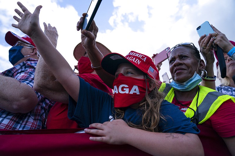 Supporters of President Donald Trump watch as Marine One arrives for a campaign rally at The Villages Polo Club, Friday, Oct. 23, 2020, in The Villages, Fla. (AP Photo/Evan Vucci)