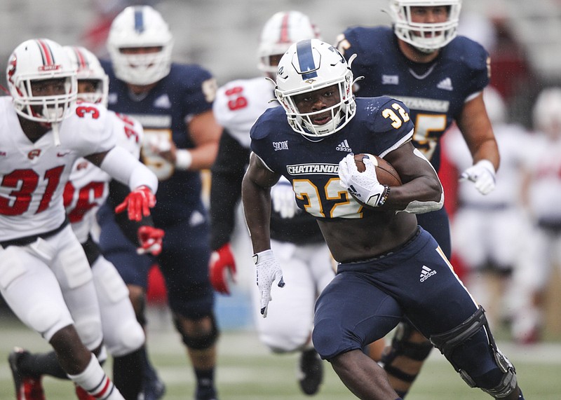 Staff photo by Troy Stolt / UTC running back Ailym Ford carries the ball during the first half of last Saturday's game at Western Kentucky.
