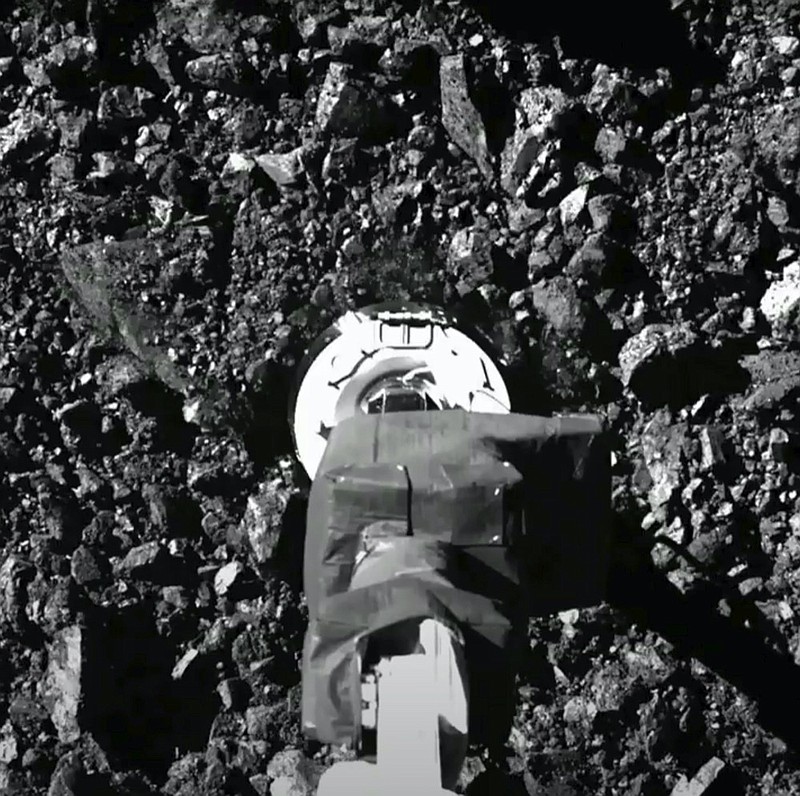 In this image taken from video released by NASA, the Osiris-Rex spacecraft touches the surface of asteroid Bennu on Tuesday, Oct. 20, 2020. (NASA via AP)


