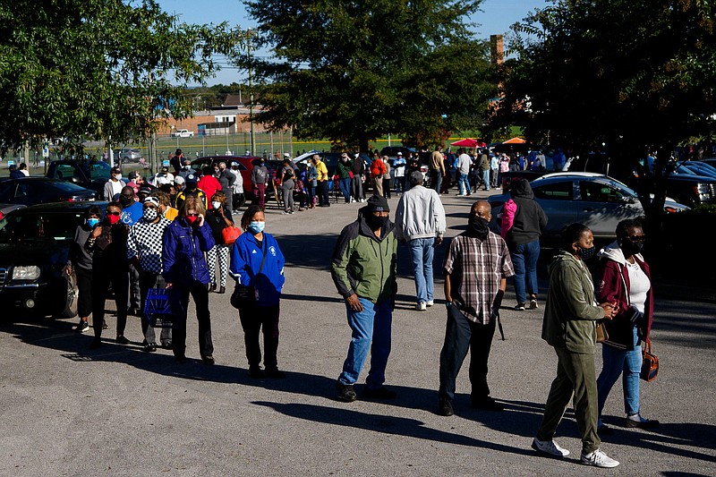 Staff photo by C.B. Schmelter / People wait in line to vote at the Brainerd Youth and Family Development Center on Wednesday, Oct. 14, the first day of early voting in Hamilton County.