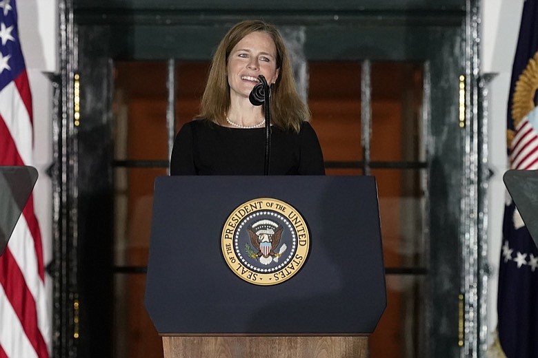 Amy Coney Barrett speaks after Supreme Court Justice Clarence Thomas administered the Constitutional Oath to her on the South Lawn of the White House White House in Washington, Monday, Oct. 26, 2020, after Barrett was confirmed to be a Supreme Court justice by the Senate earlier in the evening. (AP Photo/Alex Brandon)
