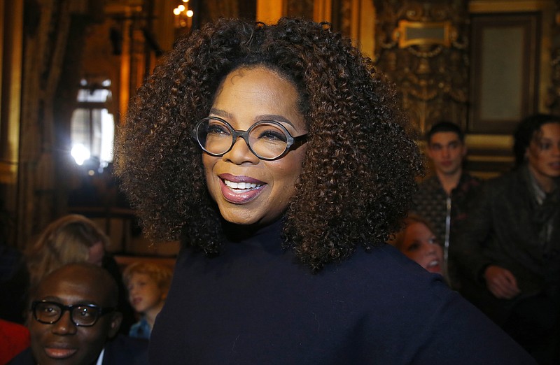 Oprah Winfrey arrives for the presentation of Stella McCartney's ready-to-wear Fall-Winter 2019-2020 fashion collection in Paris on March 4, 2019. Winfrey is setting aside her usual book club recommendations and instead citing seven personal favorites ranging from James Baldwin's landmark essays in "The Fire Next Time" to Mary Oliver's poetry collection "Devotions." She is calling her choices "The Books That See Me Through," works she values for "their ability to comfort, inspire, and enlighten" her. (AP Photo/Michel Euler, File)