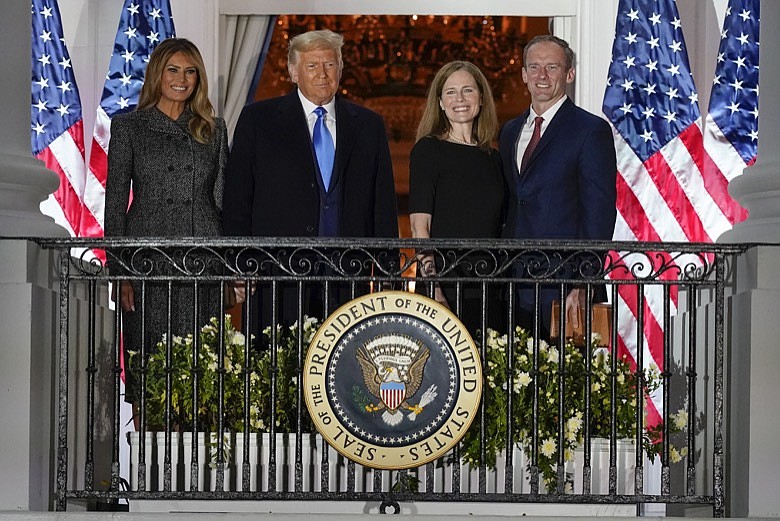 Associated Press photo by Alex Brandon/President Donald Trump, first lady Melania Trump, and Amy Coney Barrett and her husband Jesse stand on the Blue Room Balcony after Supreme Court Justice Clarence Thomas administered the Constitutional Oath to Barrett on the South Lawn of the White House in Washington on Monday.