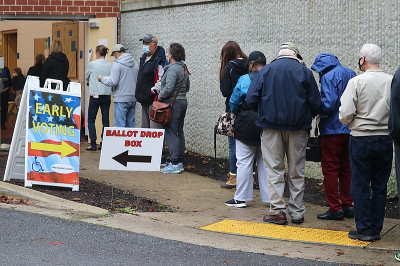 FILE - In this Monday, Oct. 26, 2020, file photo, voters wait in line to enter the Pip Moyer Recreation Center, in Annapolis, Md., on the first day of in-person early voting in the state. Tens of millions of Americans already cast ballots in the 2020 election amid record-breaking early voting during the coronavirus pandemic. But for some voters in a handful of states, casting an early ballot in-person isn't even an option. (AP Photo/Brian Witte, File)


