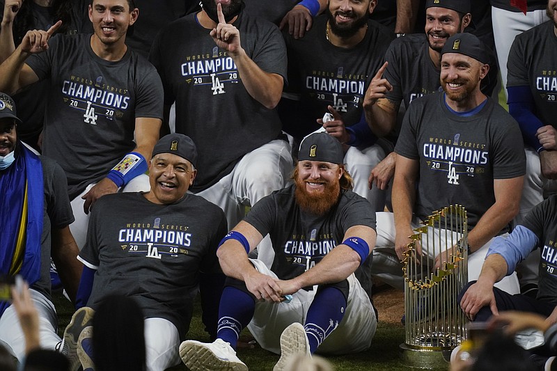AP photo by Eric Gay / Front row from left, Los Angeles Dodgers manager Dave Roberts and third baseman Justin Turner pose for a picture after the team beat the Tampa Bay Rays 3-1 in Game 6 to win the World Series on Tuesday night in Arlington, Texas.