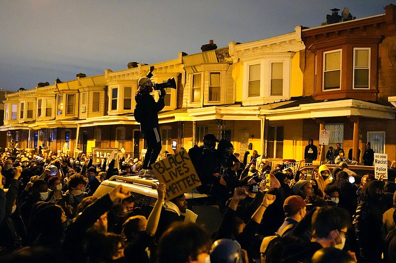 Protesters confront police during a march Tuesday Oct. 27, 2020 in Philadelphia. Hundreds of demonstrators marched in West Philadelphia over the death of Walter Wallace, a Black man who was killed by police in Philadelphia on Monday. Police shot and killed the 27-year-old on a Philadelphia street after yelling at him to drop his knife. (AP Photo/Matt Slocum)