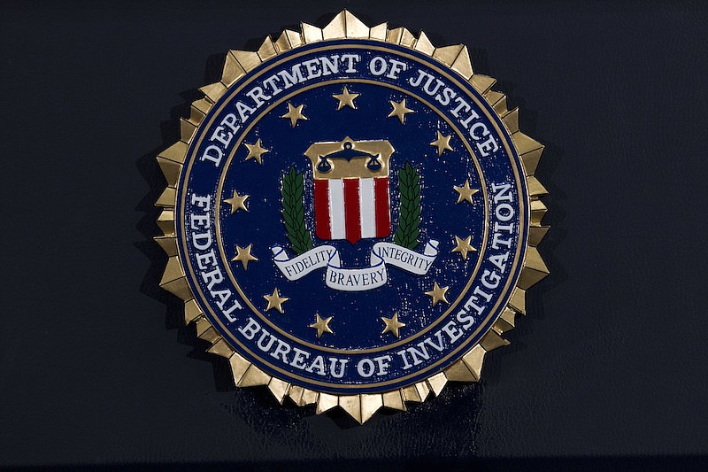 This Thursday, June 14, 2018, file photo, shows the FBI seal at a news conference at FBI headquarters in Washington. In an alert Wednesday, Oct. 28, 2020, the FBI and other federal agencies warned that cybercriminals are unleashing a wave of data-scrambling extortion attempts against the U.S. healthcare system that could lock up their information systems just as nationwide cases of COVID-19 are spiking. (AP Photo/Jose Luis Magana, File)