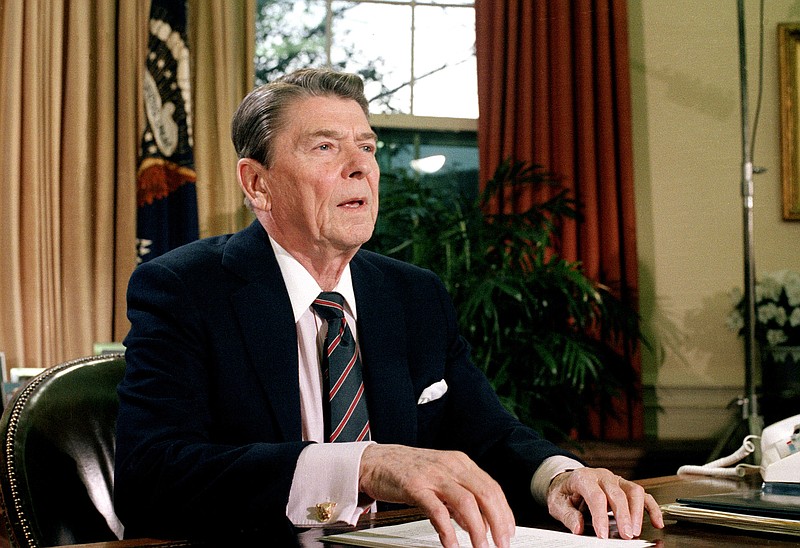 Associated Press File Photo / Twenty-two years before this 1986 photo of President Ronald Reagan addressing the nation from the Oval Office following the space shuttle Challenger explosion, he made a 1964 speech that offers lessons about 2020.