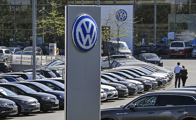 FILE - In this Monday, April 20, 2020 file photo, cars are lined up at a Volkswagen car dealer in Essen, Germany. German automaker Volkswagen says it returned to profit in the third quarter thanks to cost discipline and a rebound in global sales markets led by China after the lifting of the severe restrictions on activity in the early phase of the pandemic. (AP Photo/Martin Meissner, File)