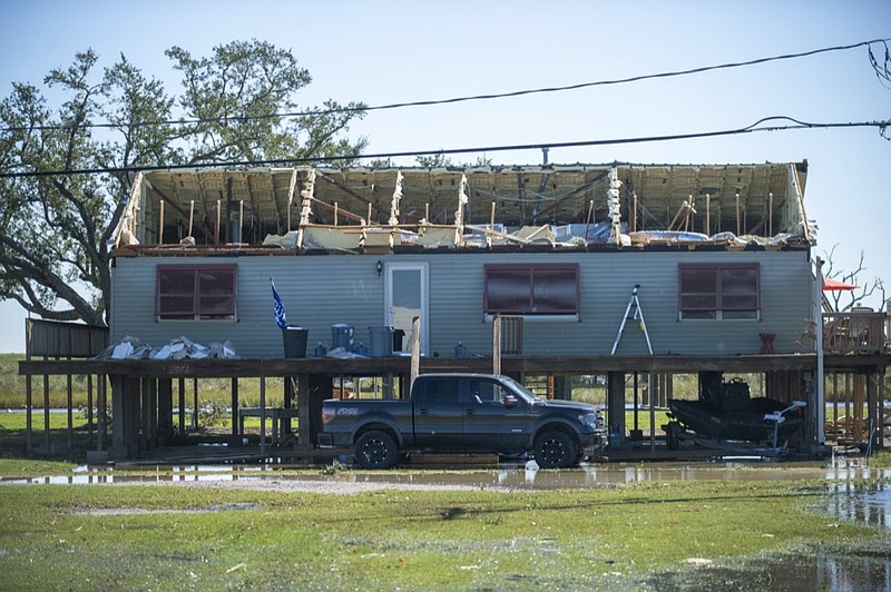 A house is damaged from Hurricane Zeta in Cocodrie, La., Thursday, Oct. 29, 2020. Gov. John Bel Edwards says officials are still assessing the extent of Zeta's damage across the southeastern parishes. (Chris Granger/The Advocate via AP)


