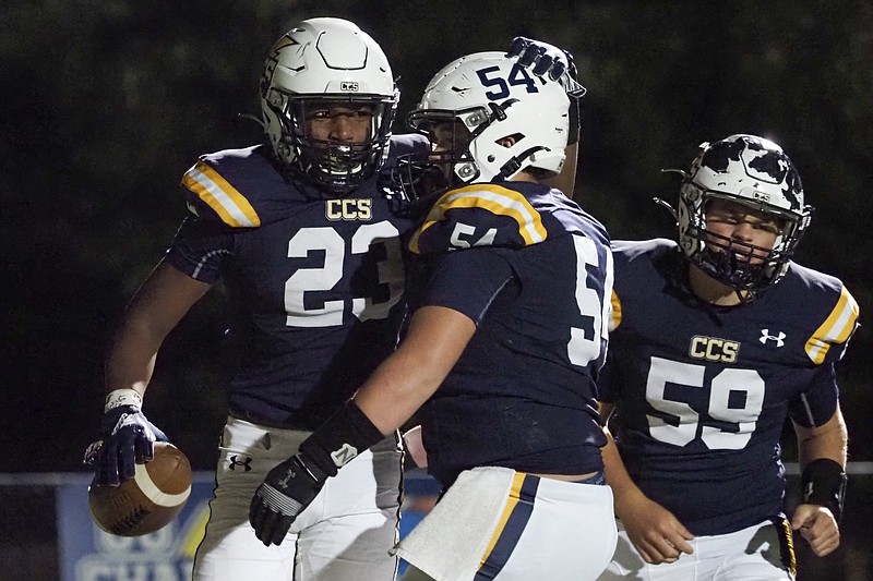 Staff photo by C.B. Schmelter / Chattanooga Christian's Javoris Havis (23) celebrates with teammate William Wall after scoring a touchdown during Friday night's 48-21 home win against Silverdale Baptist Academy to close the regular season.