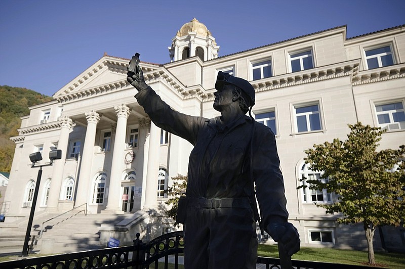 A statue of a coal miner stands in front of the Boone County Courthouse in Madison, W.Va., on Tuesday, Oct. 13, 2020. Four years after Donald Trump donned a miner's helmet at a West Virginia campaign rally and vowed to save a dying industry, coal has not come roaring back. The fuel has been outmatched against cheaper, cleaner natural gas and renewable energy. But many West Virginians applaud Trump's efforts and remain loyal as he seeks a second term. (AP Photo/Chris Jackson)



