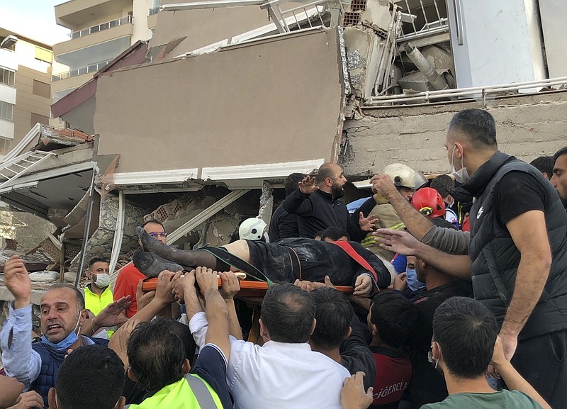 Rescue workers and local people carry a wounded person found in the debris of a collapsed building, in Izmir, Turkey, Friday, Oct. 30, 2020, after a strong earthquake in the Aegean Sea has shaken Turkey and Greece. Turkey's Disaster and Emergency Management Presidency said Friday's earthquake was centered in the Aegean at a depth of 16,5 kilometers (10.3 miles) and registered at a 6.6 magnitude. (AP Photo/Ismail Gokmen)


