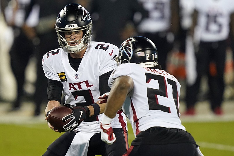 AP photo by Gerry Broome / Atlanta Falcons quarterback Matt Ryan hands off to Todd Gurley during Thursday night's game against the Carolina Panthers in Charlotte, N.C. Ryan and Gurley helped lead the Falcons to a 25-17 win in the NFC South matchup, their second victory in the past three games.