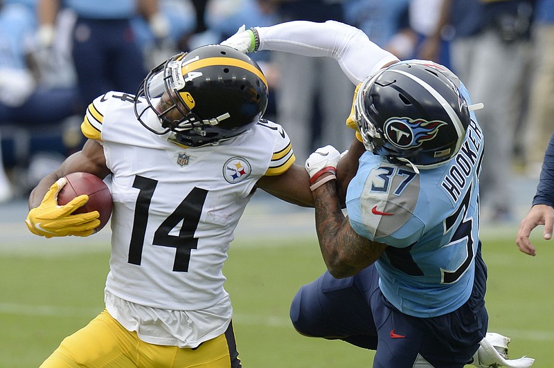 AP photo by Mark Zaleski / Tennessee Titans safety Amani Hooker tries to bring down Pittsburgh Steelers wide receiver Ray-Ray McCloud during the first half of last Sunday's game in Nashville.