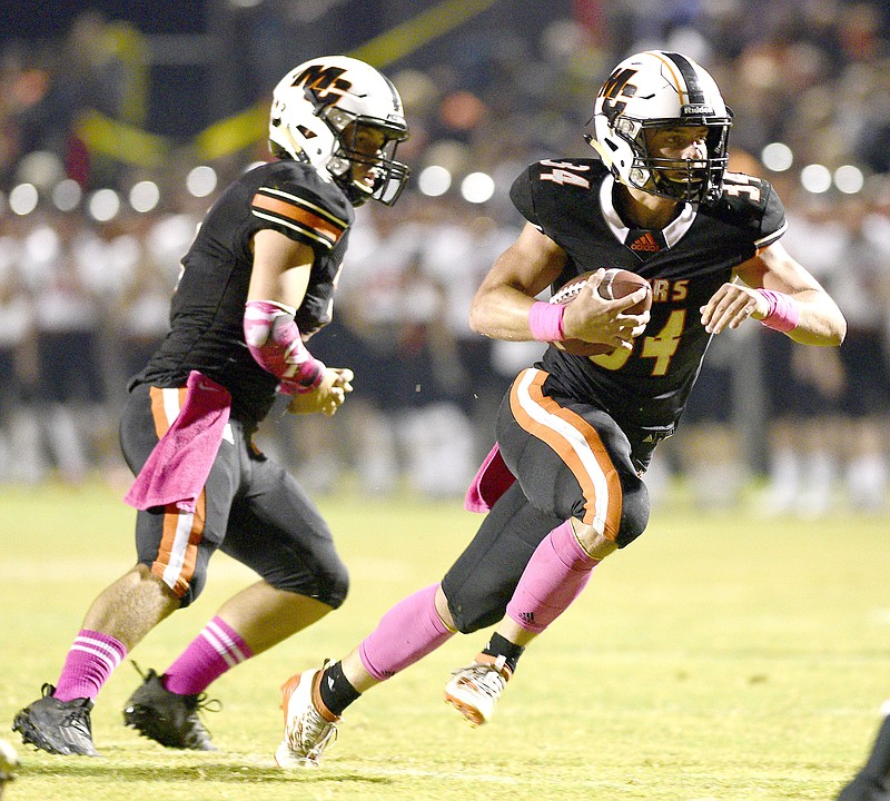 Staff Photo by Robin Rudd / Meigs County's Will Meadows (34) runs with the ball after taking the handoff from quarterback Logan Carroll (2).  The South Pittsburg Pirates visited the Meigs County Tigers at the school's Jewell Field on Friday, October 9, 2020, in Decatur, Tenn.